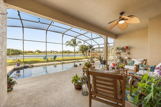 view of patio featuring an outdoor pool, a water view, a lanai, and a ceiling fan