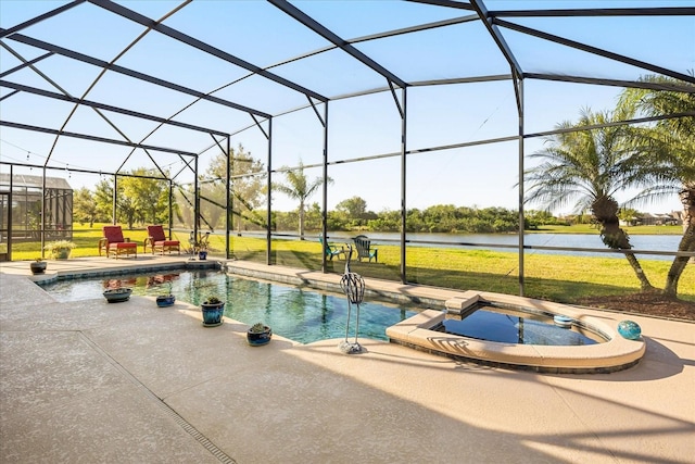 view of pool featuring glass enclosure, a yard, a pool with connected hot tub, and a patio area