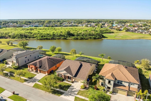 drone / aerial view with a residential view and a water view