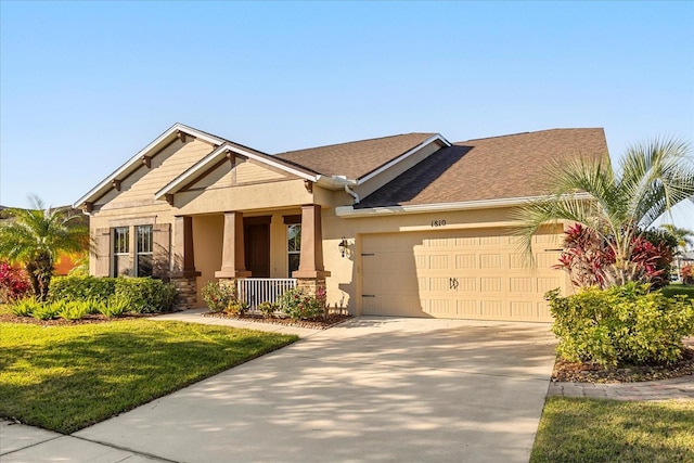 craftsman inspired home with a front yard, stucco siding, a garage, stone siding, and driveway