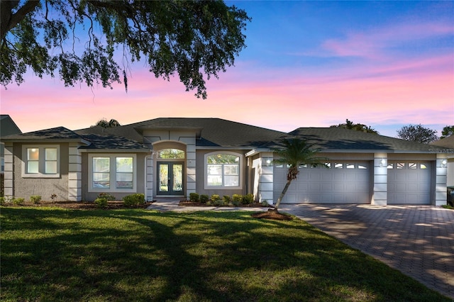 8611 Dover Oaks Ct, Orlando, FL 32836 - view of front facade with stucco siding, driveway, french doors, an attached garage, and a front lawn