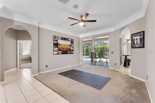 8611 Dover Oaks Ct, Orlando, FL 32836 - exercise area with crown molding, ceiling fan, arched walkways, a textured ceiling, and light colored carpet