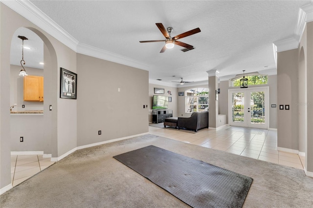 8611 Dover Oaks Ct, Orlando, FL 32836 - interior space with ornamental molding, light carpet, a textured ceiling, ceiling fan, and arched walkways