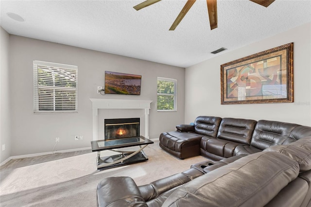 8611 Dover Oaks Ct, Orlando, FL 32836 - living area featuring visible vents, ceiling fan, carpet, and a glass covered fireplace