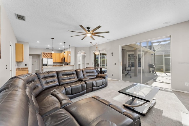8611 Dover Oaks Ct, Orlando, FL 32836 - living room with visible vents, ceiling fan, light carpet, and a textured ceiling