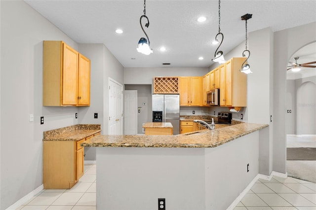 8611 Dover Oaks Ct, Orlando, FL 32836 - kitchen with a peninsula, appliances with stainless steel finishes, light tile patterned flooring, and light brown cabinetry