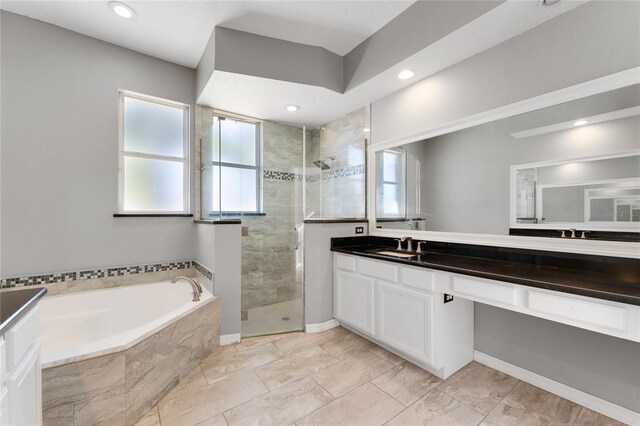 8611 Dover Oaks Ct, Orlando, FL 32836 - bathroom with a garden tub, vanity, recessed lighting, marble finish floor, and a stall shower