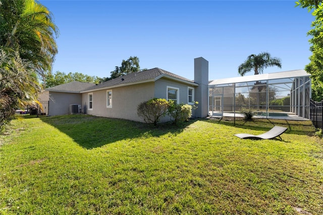 8611 Dover Oaks Ct, Orlando, FL 32836 - exterior space featuring a lawn, stucco siding, central AC unit, and glass enclosure