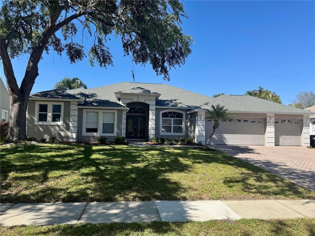 8611 Dover Oaks Ct, Orlando, FL 32836 - ranch-style home featuring a garage, a front yard, driveway, and stucco siding