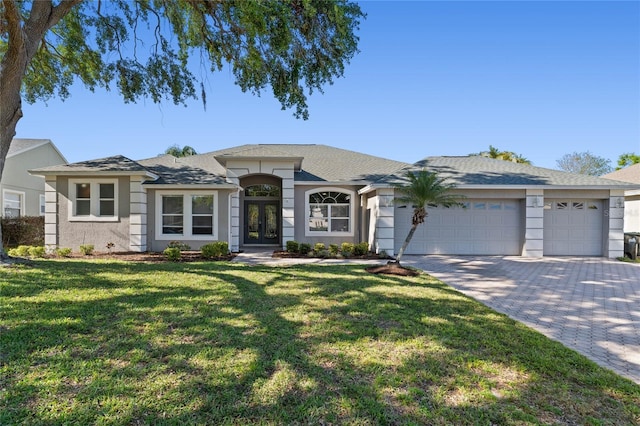 8611 Dover Oaks Ct, Orlando, FL 32836 - view of front of property with a front yard, a garage, stucco siding, french doors, and decorative driveway