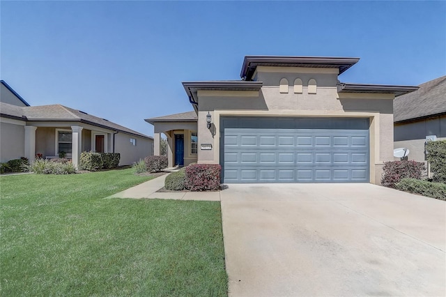 prairie-style house featuring stucco siding, concrete driveway, a front yard, and a garage