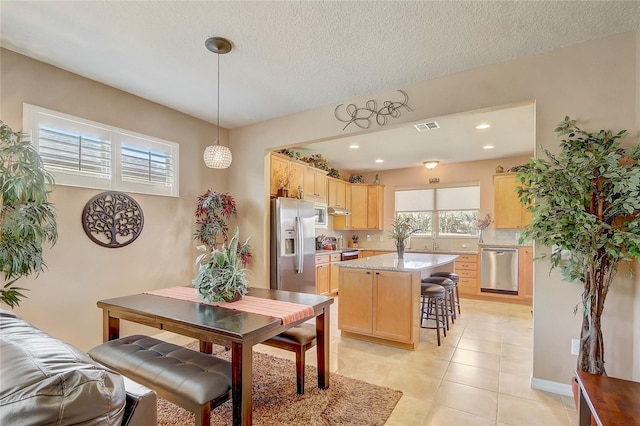 dining area with light tile patterned flooring, recessed lighting, visible vents, and a textured ceiling