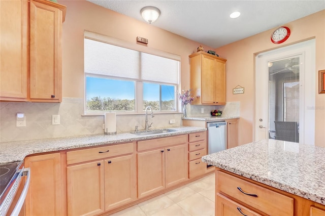 kitchen with light brown cabinets, a sink, dishwasher, range, and tasteful backsplash