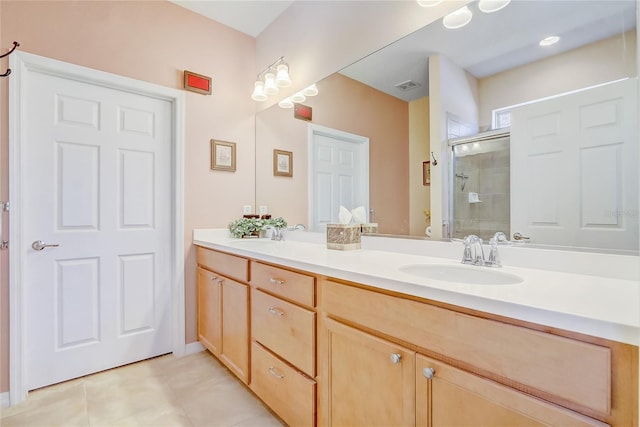 bathroom with visible vents, toilet, double vanity, a stall shower, and a sink