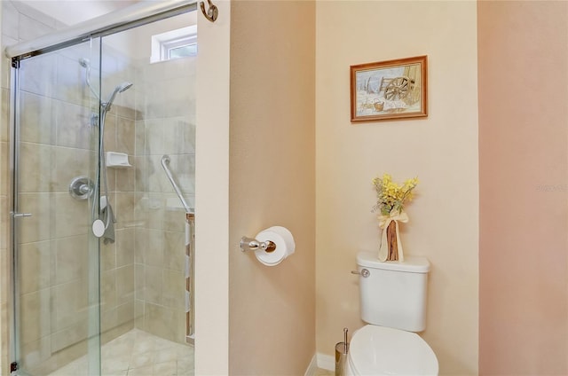 full bathroom featuring toilet and a stall shower