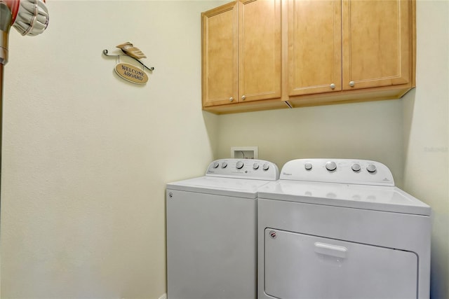 washroom featuring cabinet space and washer and dryer