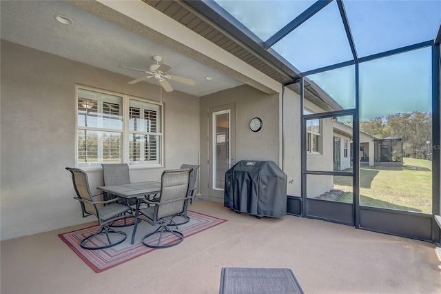 sunroom / solarium with beamed ceiling and ceiling fan