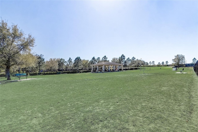 view of property's community with a gazebo, a lawn, and a rural view