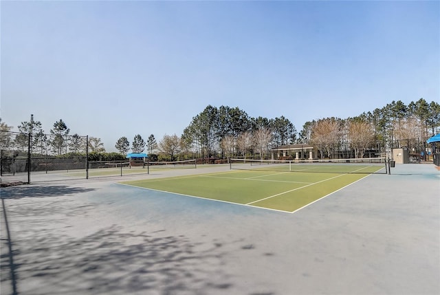 view of tennis court with fence