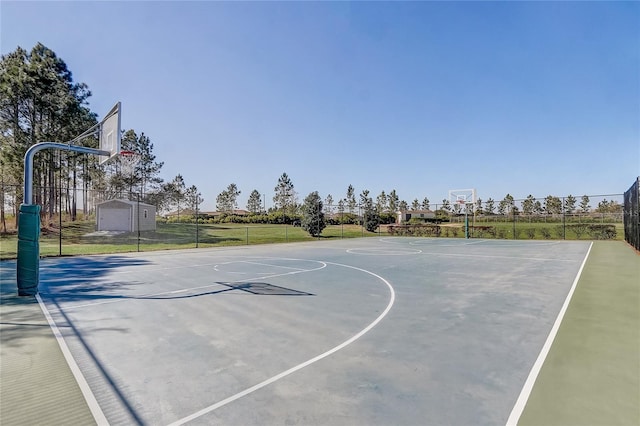 view of basketball court with community basketball court and fence