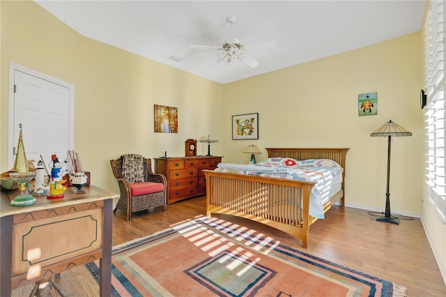 bedroom featuring baseboards, ceiling fan, and light wood finished floors