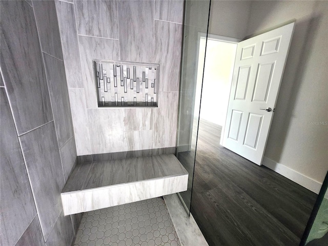 interior details featuring baseboards and walk in shower