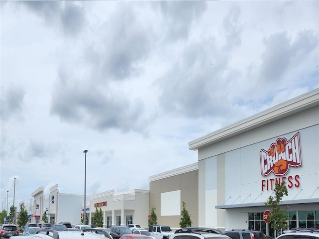 view of building exterior with uncovered parking