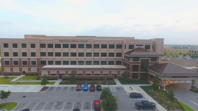 view of building exterior with uncovered parking