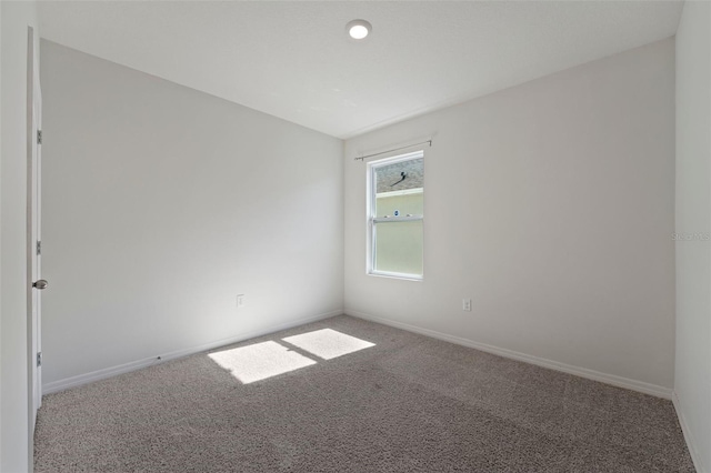 carpeted empty room with baseboards