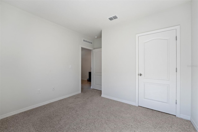 unfurnished bedroom with visible vents, carpet flooring, and baseboards