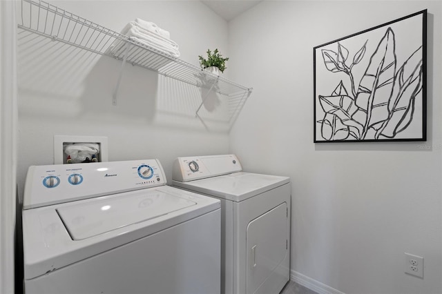 clothes washing area featuring laundry area, independent washer and dryer, and baseboards