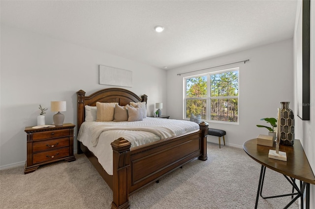 bedroom featuring baseboards and light carpet