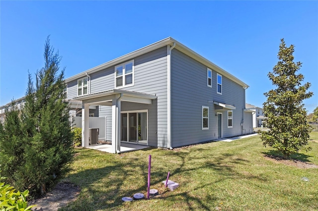 back of house featuring a patio area, central AC unit, and a lawn