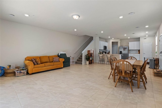 dining area featuring recessed lighting and stairway