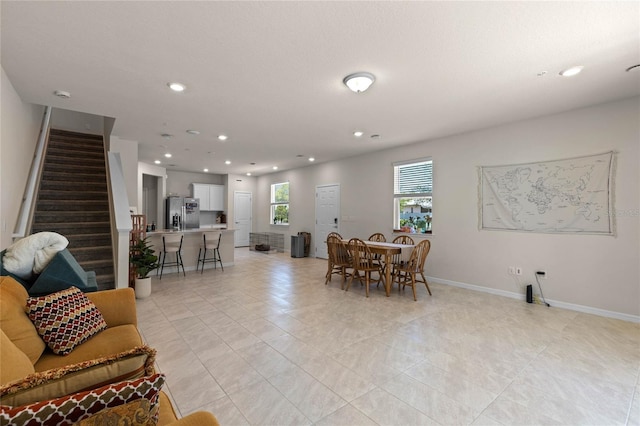 dining space with light tile patterned flooring, stairway, recessed lighting, and baseboards