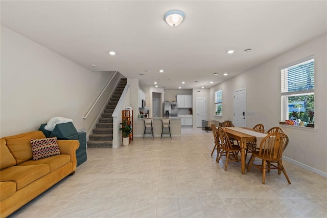 dining space featuring recessed lighting, stairs, and baseboards