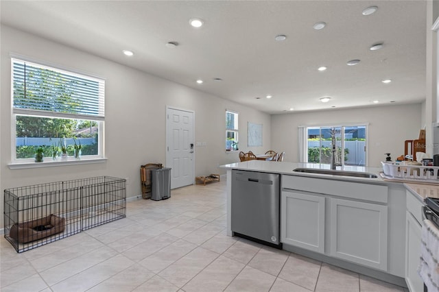 kitchen with a sink, recessed lighting, light tile patterned flooring, stove, and dishwasher