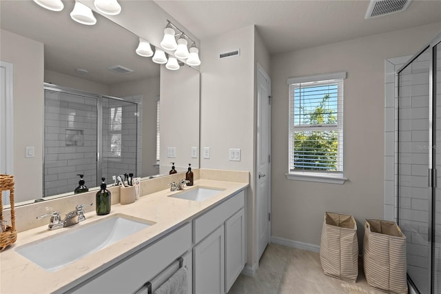 full bath featuring a shower stall, visible vents, and a sink