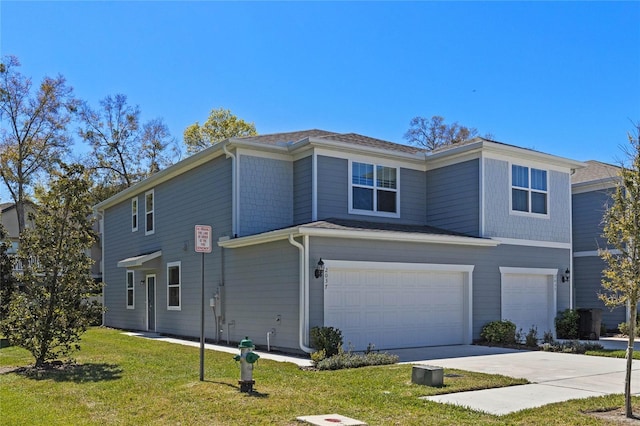 exterior space with driveway, an attached garage, and a yard