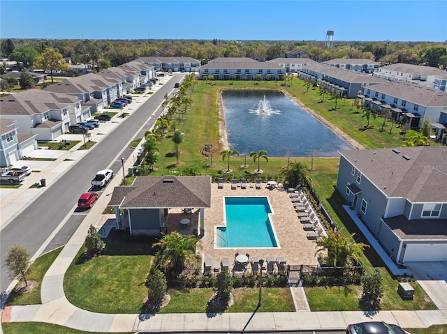 drone / aerial view with a water view and a residential view