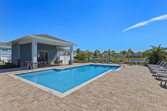 pool featuring a patio and fence