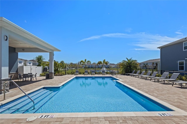 pool featuring a patio area and fence