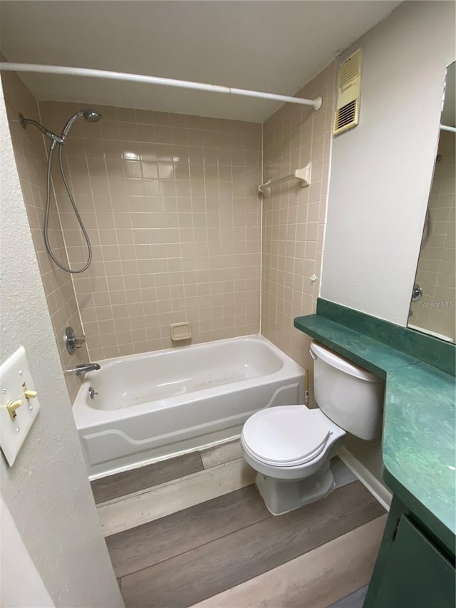 full bathroom with vanity, wood finished floors, visible vents, shower / washtub combination, and toilet