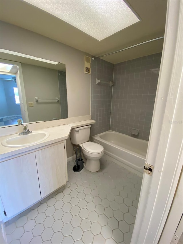 full bathroom with tub / shower combination, toilet, tile patterned floors, a textured ceiling, and vanity