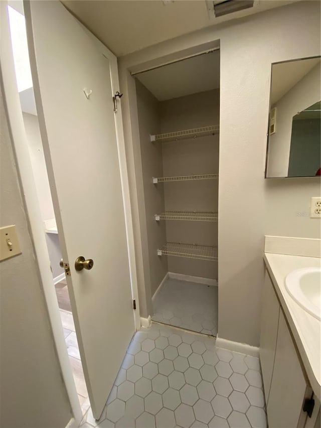 bathroom with visible vents, vanity, and baseboards