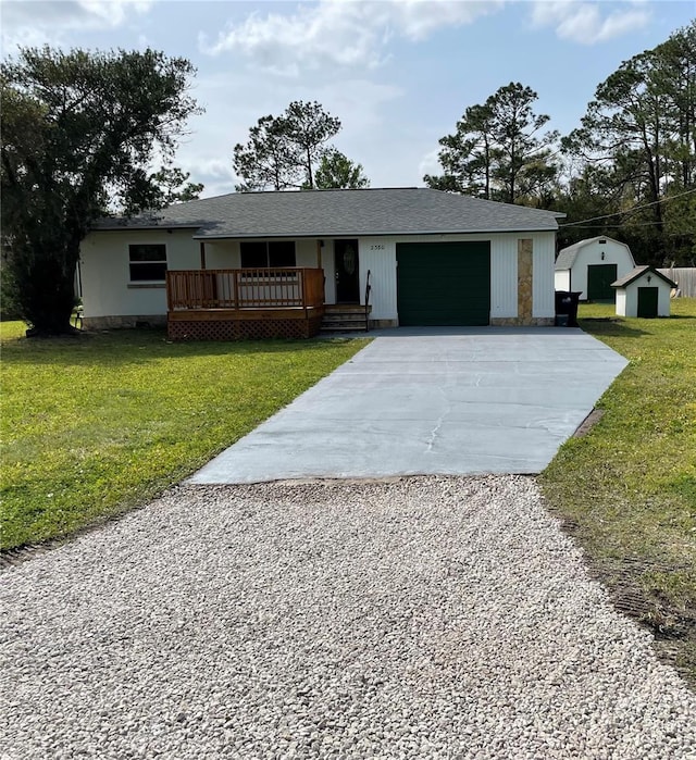 ranch-style house with a front yard, a garage, and driveway