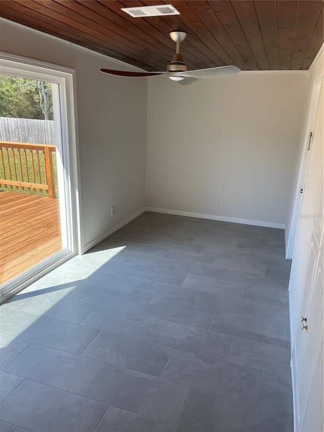 spare room featuring baseboards, wooden ceiling, and tile patterned flooring