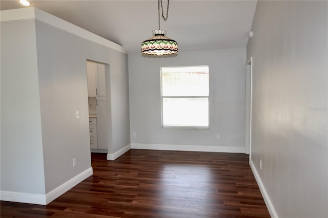 empty room featuring baseboards and wood finished floors