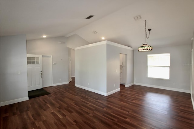 unfurnished room with baseboards, lofted ceiling, visible vents, and dark wood-style flooring