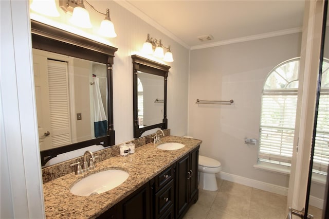 bathroom with a sink, a wealth of natural light, and crown molding